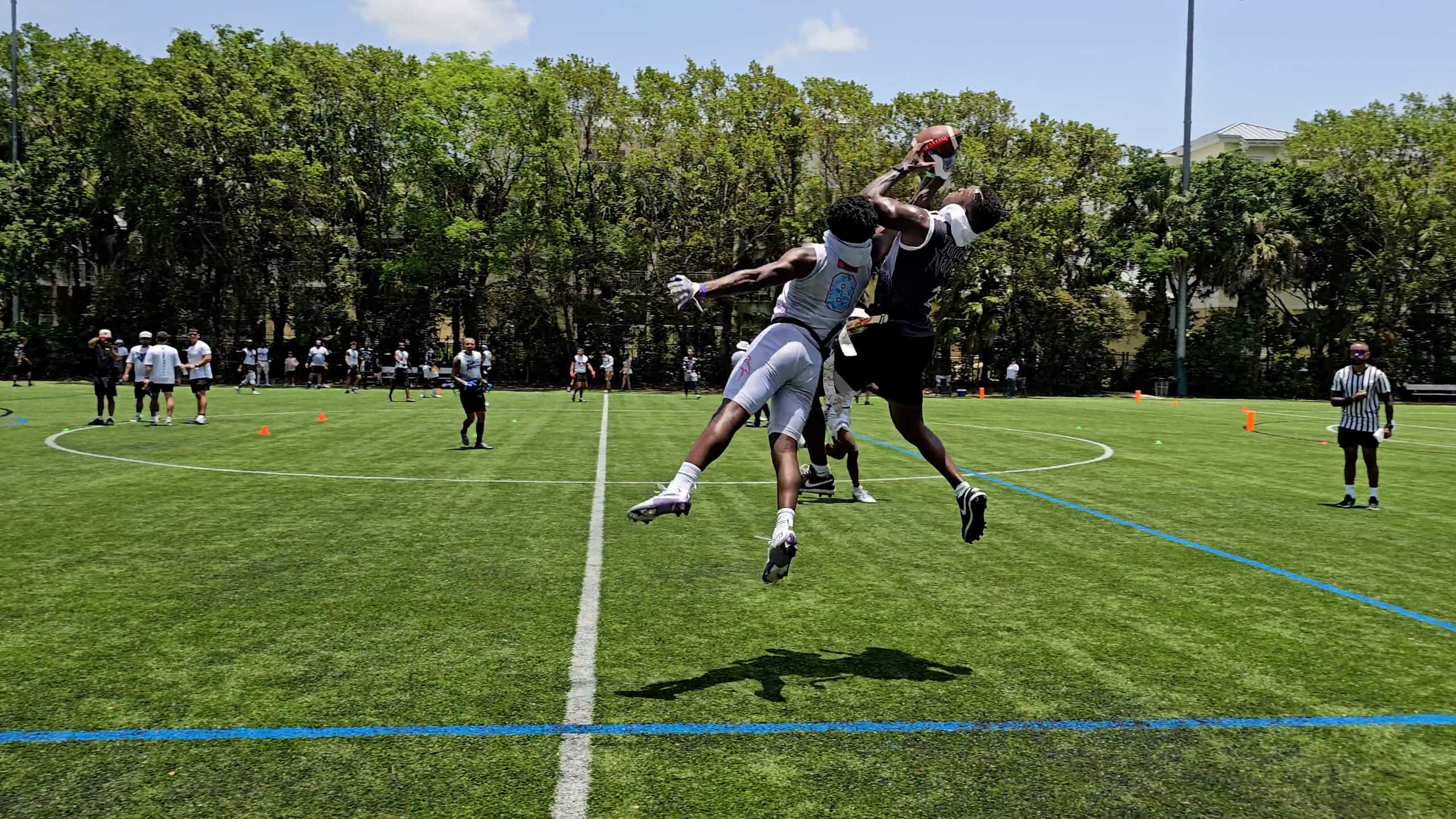 Velocity flag football players competing for a catch